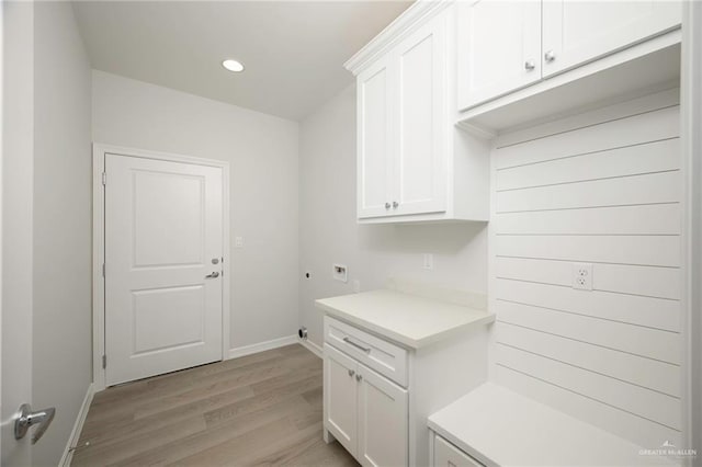 mudroom with light hardwood / wood-style floors