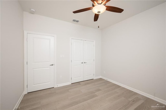 unfurnished bedroom with light hardwood / wood-style floors and ceiling fan