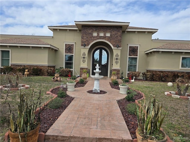 doorway to property with a lawn