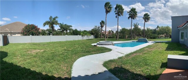 view of swimming pool with a yard