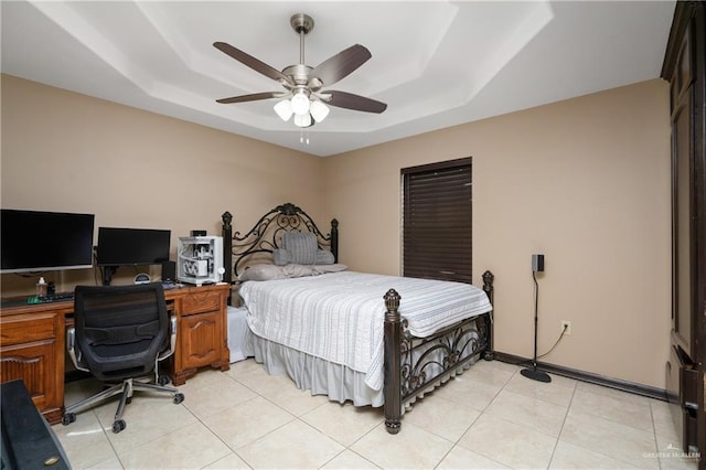 bedroom featuring a tray ceiling, ceiling fan, and light tile patterned flooring