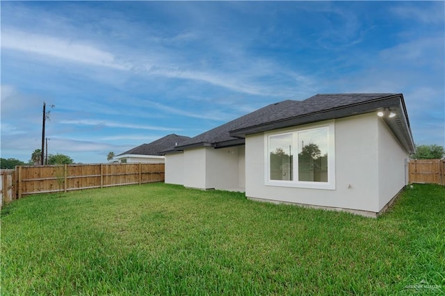 back of house featuring a yard