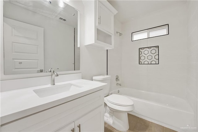 full bathroom with tiled shower / bath, vanity, toilet, and hardwood / wood-style floors