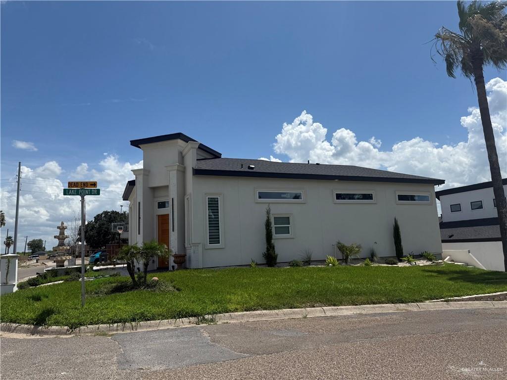 1901 Lake Point Dr, Mission, TX 78572 - view of home's exterior featuring stucco siding and a lawn