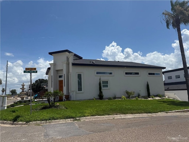 1901 Lake Point Dr, Mission, TX 78572 - view of home's exterior featuring stucco siding and a lawn
