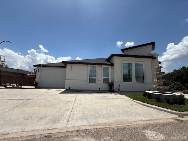 1901 Lake Point Dr, Mission, TX 78572 - view of front facade with an attached garage, driveway, and stucco siding