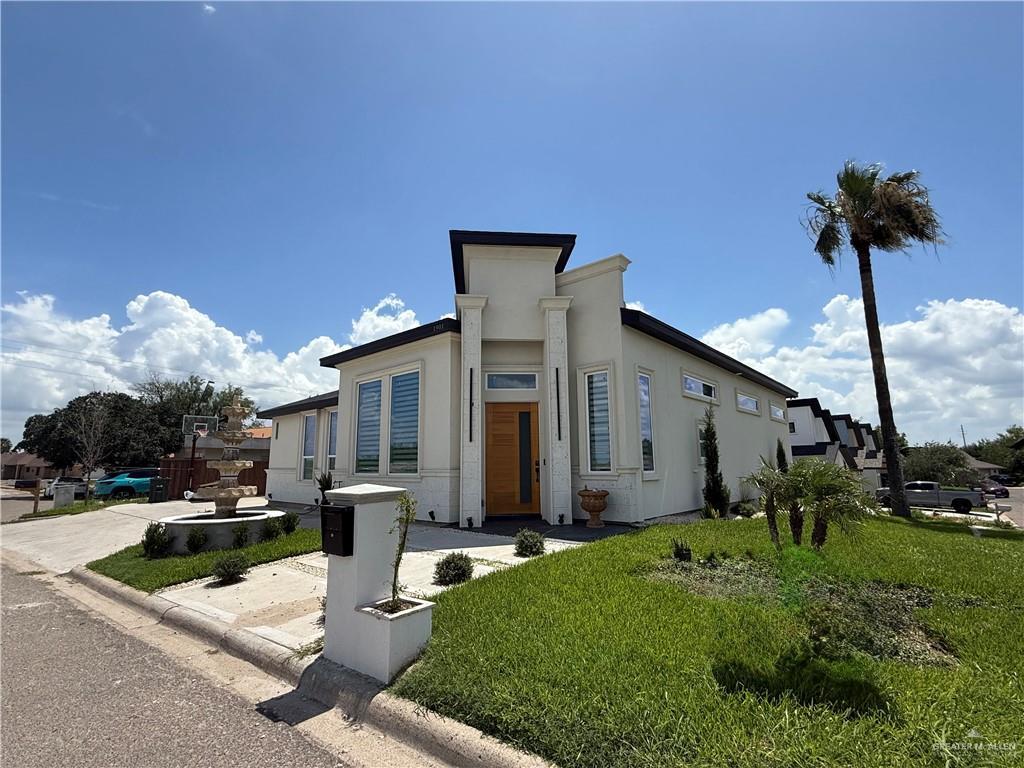 1901 Lake Point Dr, Mission, TX 78572 - contemporary house with a front lawn and stucco siding