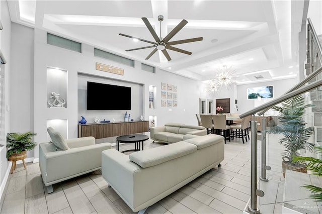 living room featuring ceiling fan with notable chandelier and a high ceiling