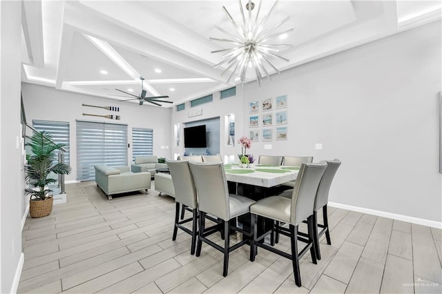 dining space with beam ceiling, ceiling fan with notable chandelier, and light wood-type flooring