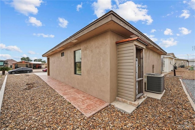 2005 E Bogey Dr, Mission, TX 78572 - view of side of home featuring central air condition unit and stucco siding