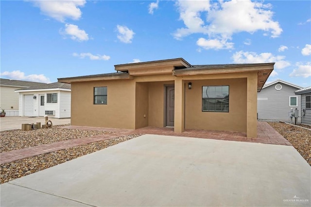 2005 E Bogey Dr, Mission, TX 78572 - view of front of house with stucco siding and a patio area