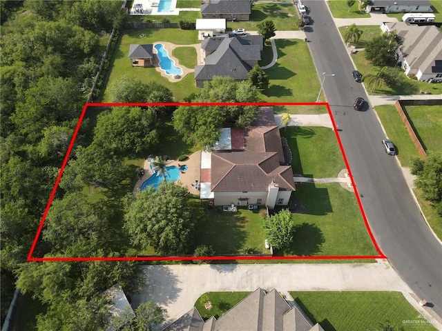 2724 Wildwood Dr, Weslaco, TX 78596 - aerial view of residential area with a pool area and property parcel outlined