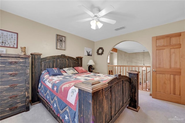 2724 Wildwood Dr, Weslaco, TX 78596 - bedroom featuring light colored carpet, arched walkways, and ceiling fan