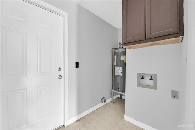 laundry area featuring washer hookup, light tile patterned flooring, cabinets, and electric water heater