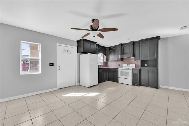 kitchen featuring ceiling fan, light tile patterned floors, and white appliances