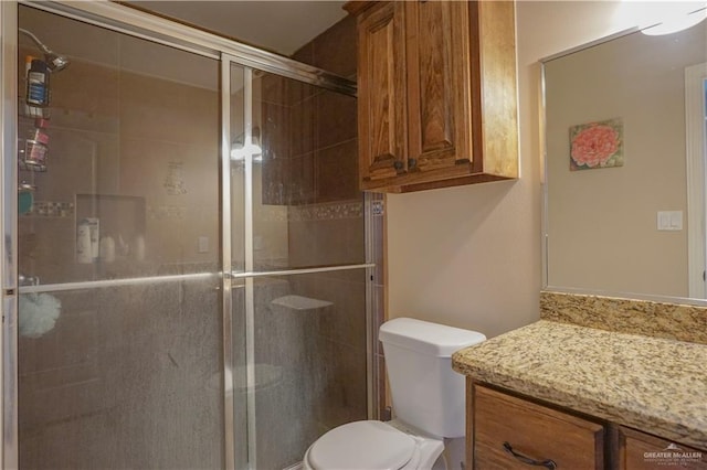 bathroom with toilet, vanity, and walk in shower