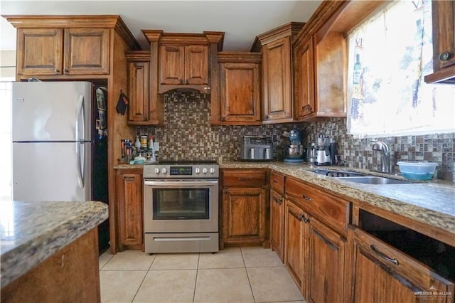 kitchen with tasteful backsplash, sink, stainless steel appliances, and light tile patterned flooring