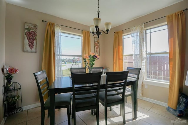 tiled dining space featuring a notable chandelier