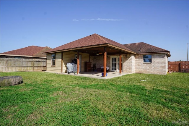 rear view of house featuring a patio area and a lawn