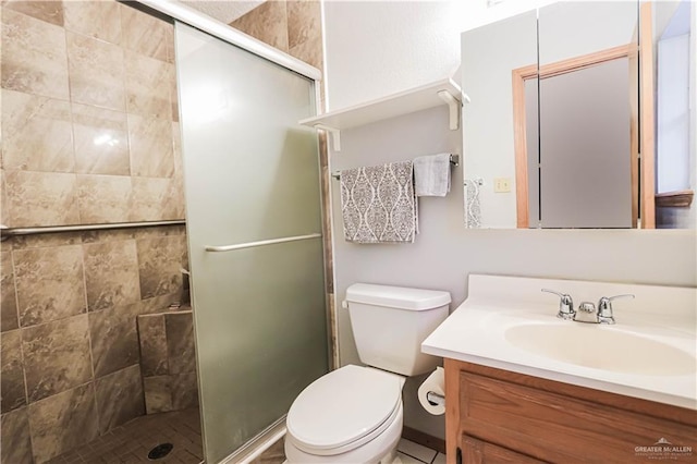 bathroom with vanity, toilet, and a shower with door