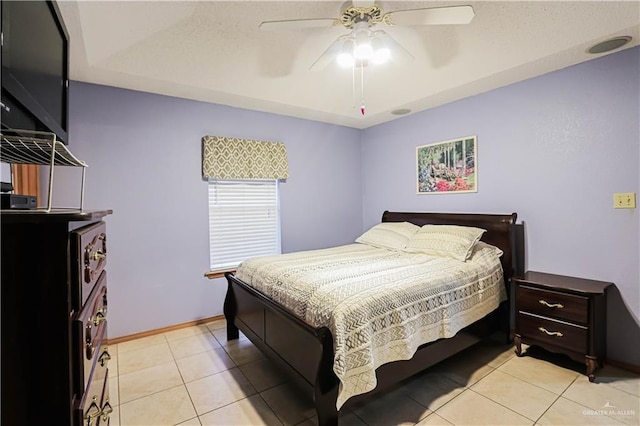 tiled bedroom featuring ceiling fan