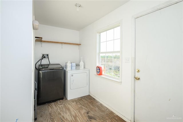 washroom featuring laundry area, light wood-style flooring, and separate washer and dryer