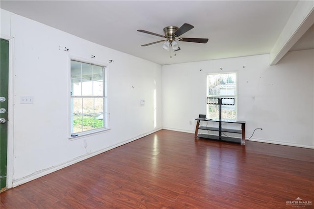 unfurnished room featuring plenty of natural light, ceiling fan, and wood finished floors