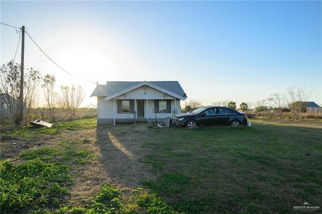 bungalow-style house featuring a front yard