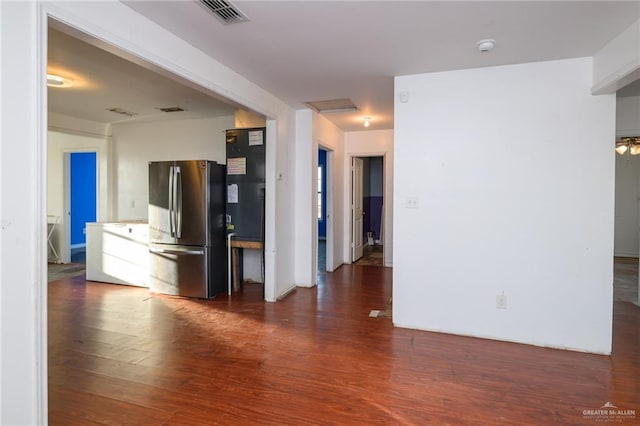 interior space with wood finished floors, visible vents, and attic access