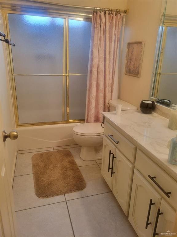 full bathroom with shower / tub combo, vanity, tile patterned flooring, and toilet