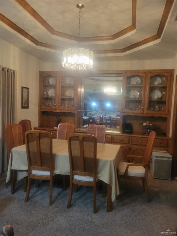 carpeted dining space featuring a raised ceiling