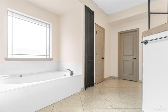 1704 Yellow Stone St, Edinburg, TX 78542 - bathroom with a bath, tile patterned flooring, and baseboards