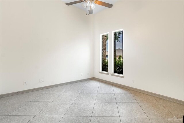 1704 Yellow Stone St, Edinburg, TX 78542 - unfurnished room featuring light tile patterned floors, a ceiling fan, baseboards, and a towering ceiling