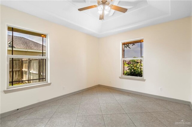 1704 Yellow Stone St, Edinburg, TX 78542 - unfurnished room featuring a tray ceiling, baseboards, ceiling fan, and tile patterned flooring
