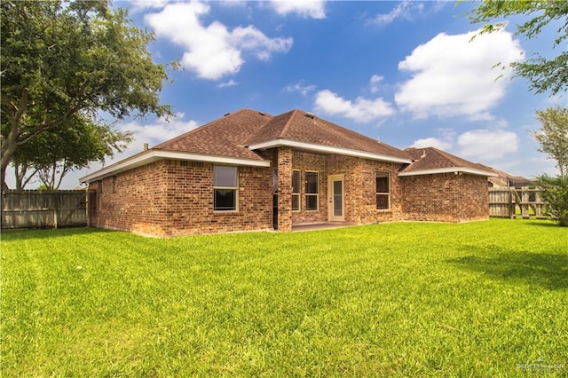 1704 Yellow Stone St, Edinburg, TX 78542 - back of property featuring brick siding, a patio, and roof with shingles