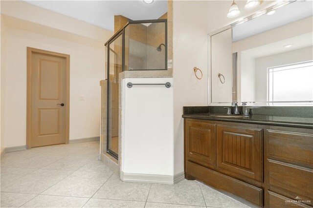 1704 Yellow Stone St, Edinburg, TX 78542 - bathroom featuring a shower stall, tile patterned flooring, vanity, and baseboards