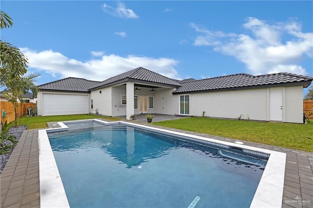 view of pool with a lawn, ceiling fan, and a patio