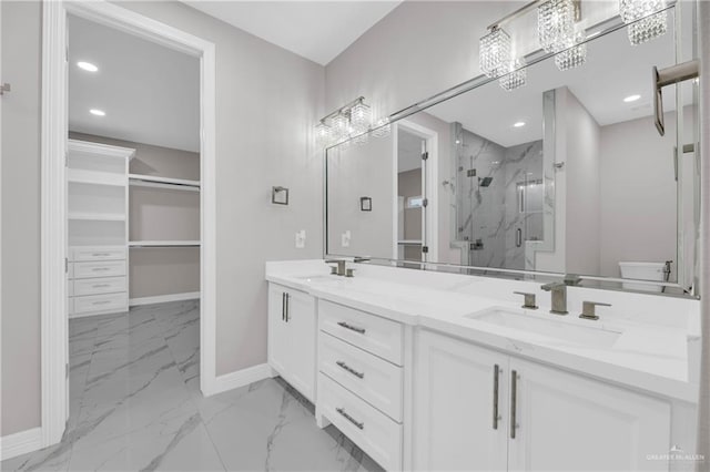 bathroom with a shower with shower door and vanity