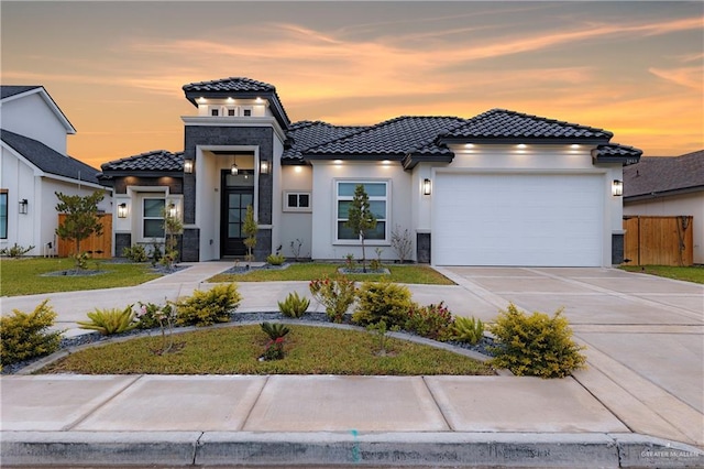 view of front of house featuring a garage and a yard