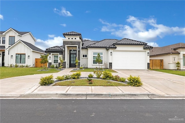 view of front of home with a garage and a front lawn