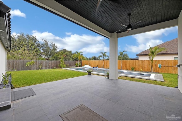 view of patio / terrace featuring a fenced in pool and ceiling fan