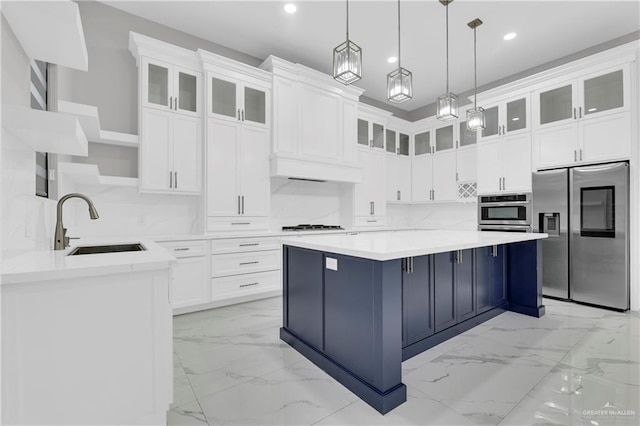 kitchen featuring white cabinets, pendant lighting, and appliances with stainless steel finishes