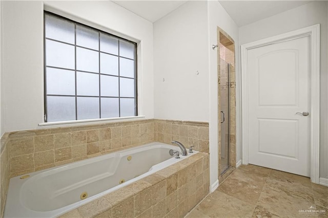 bathroom with a shower stall and a whirlpool tub