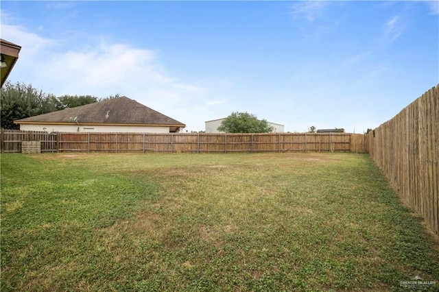 view of yard with a fenced backyard