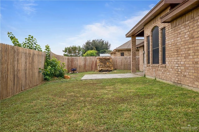 view of yard with a patio area and a fenced backyard