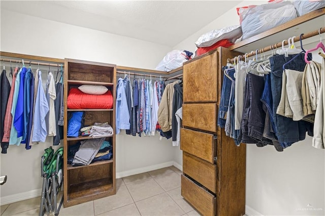 walk in closet featuring light tile patterned flooring