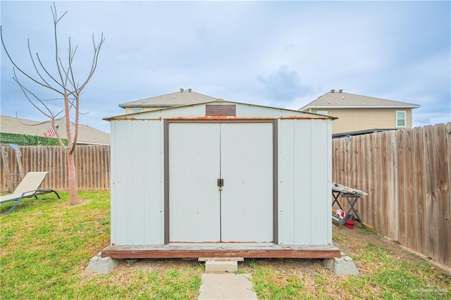 view of shed featuring a fenced backyard