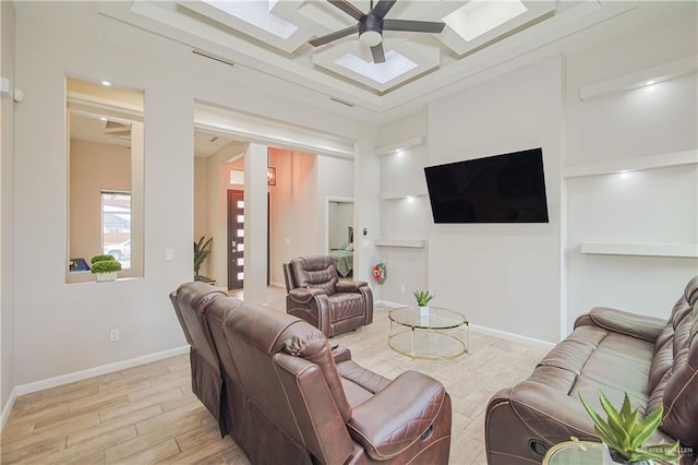 living area featuring baseboards, visible vents, coffered ceiling, a ceiling fan, and light wood-type flooring