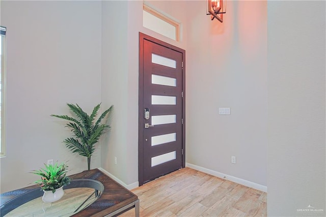 entryway featuring light wood-style flooring and baseboards