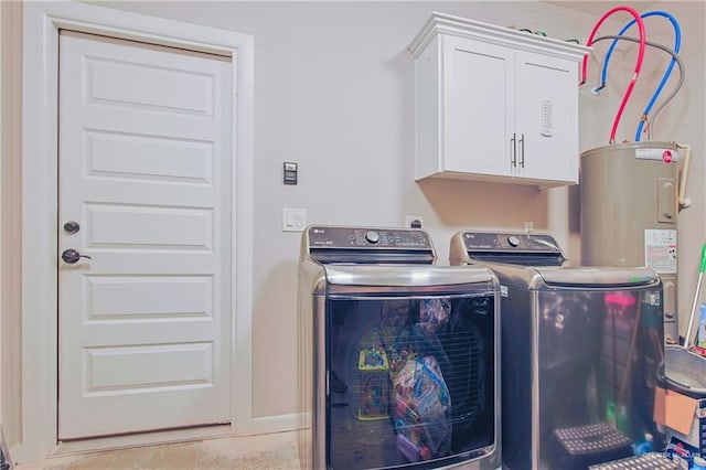 washroom featuring cabinet space, water heater, baseboards, and washer and dryer